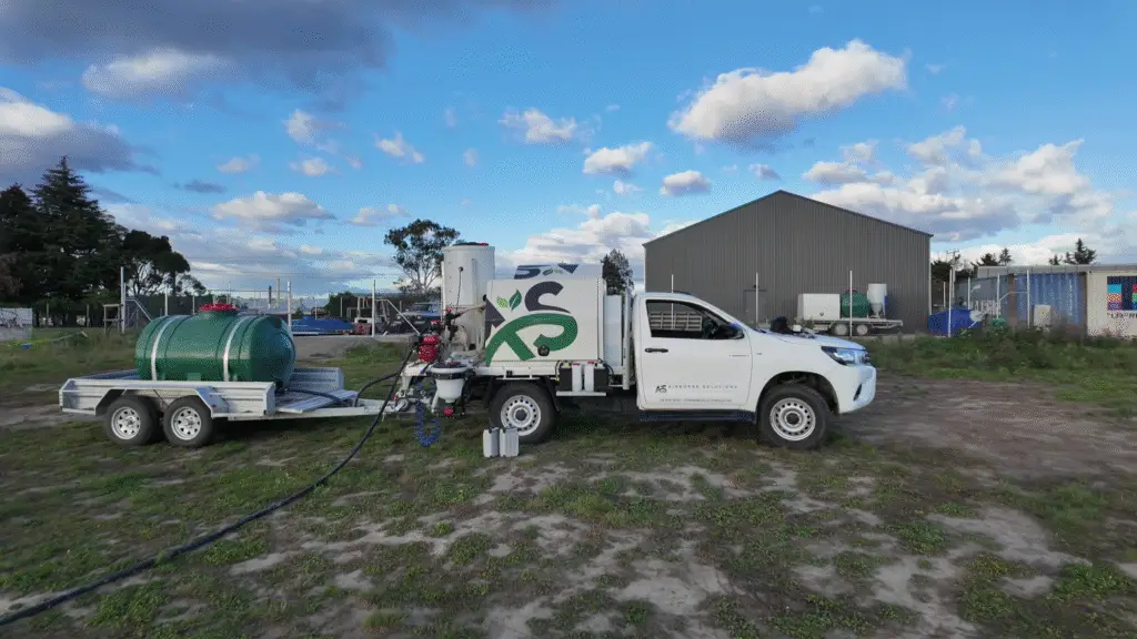Side view of Airborne Solutions’ drone spray unit and water trailer setup