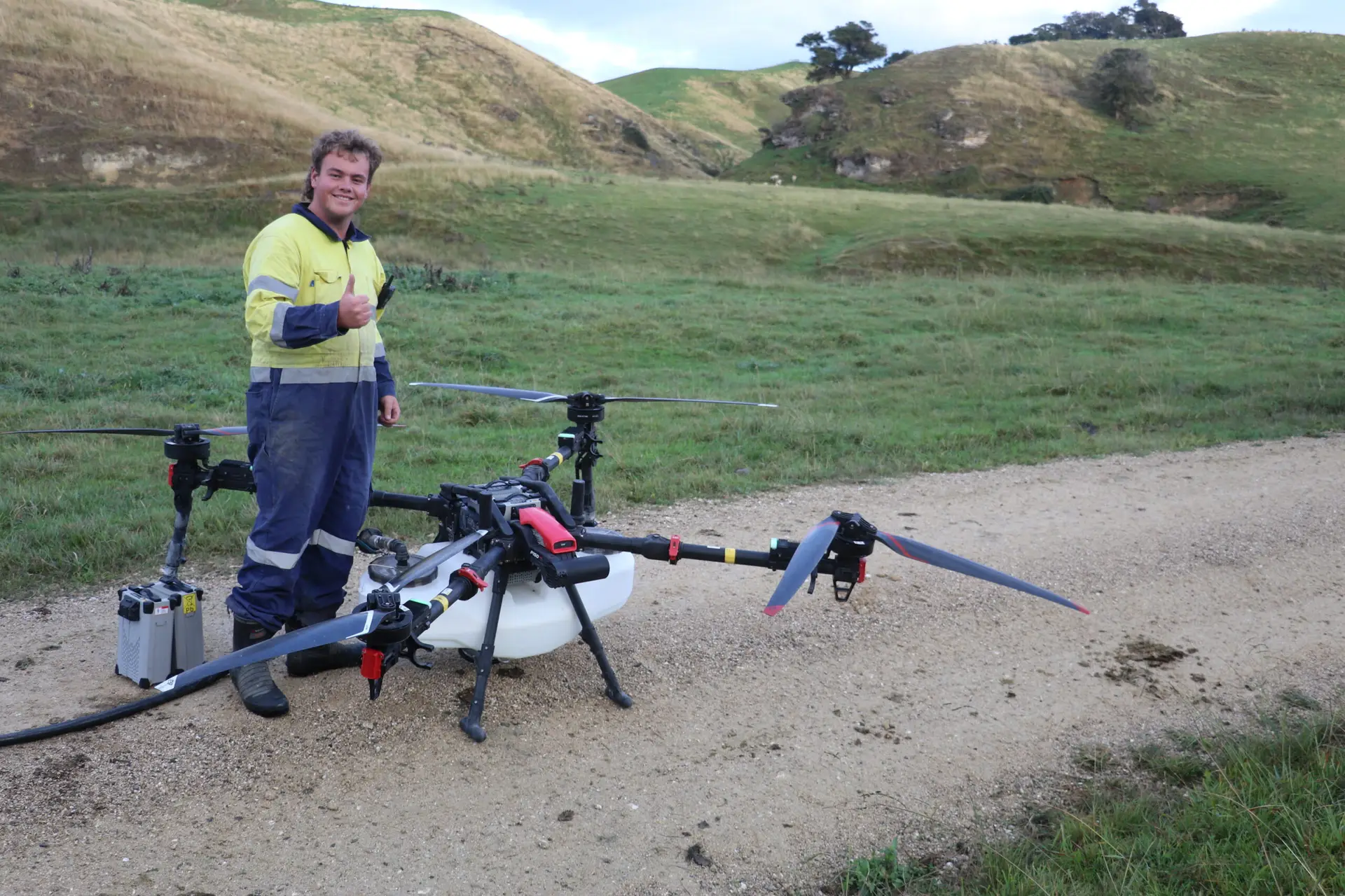 Airborne Solutions team member standing beside XAG P150 Max