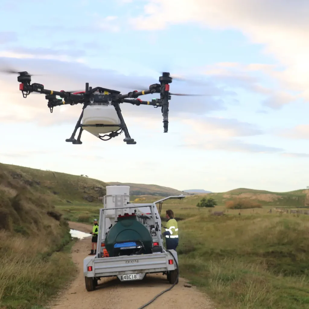 XAG drone hovering behind Airborne Solutions Fieldboss package on trailer